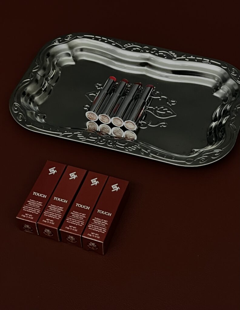Pugai Lip Wet displayed with a silver tray against a burgundy background